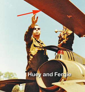 Huey and Fergie look at hole in rotor blade of Medevac 2.